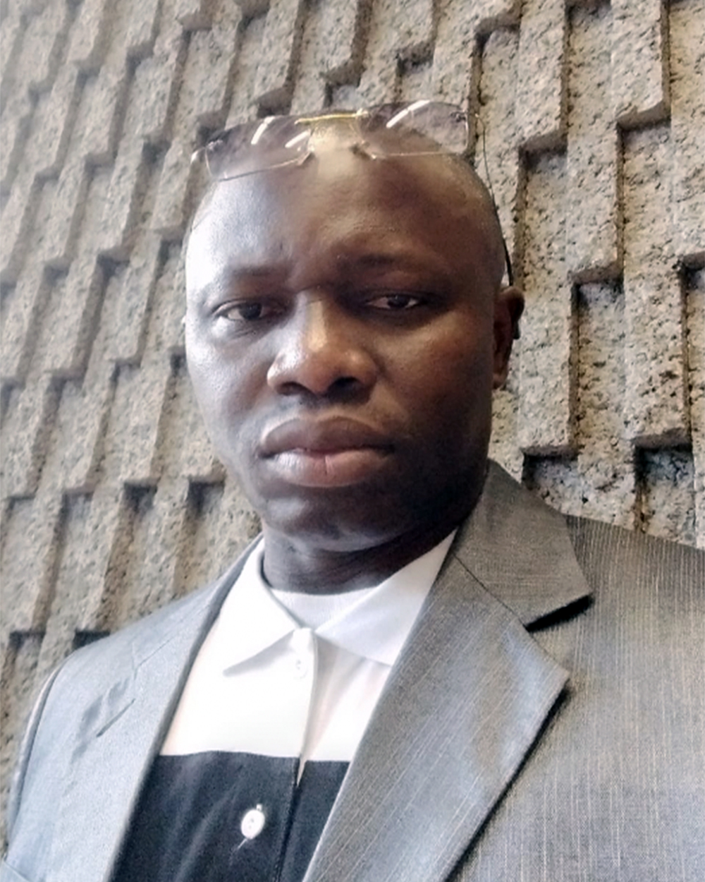 photo of a man standing against a wall